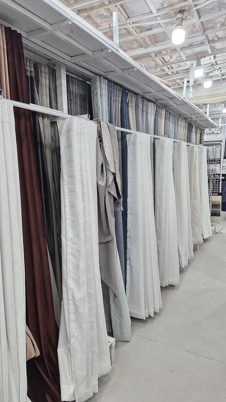 Rows of curtain fabrics hanging in the Frontline Curtains shop