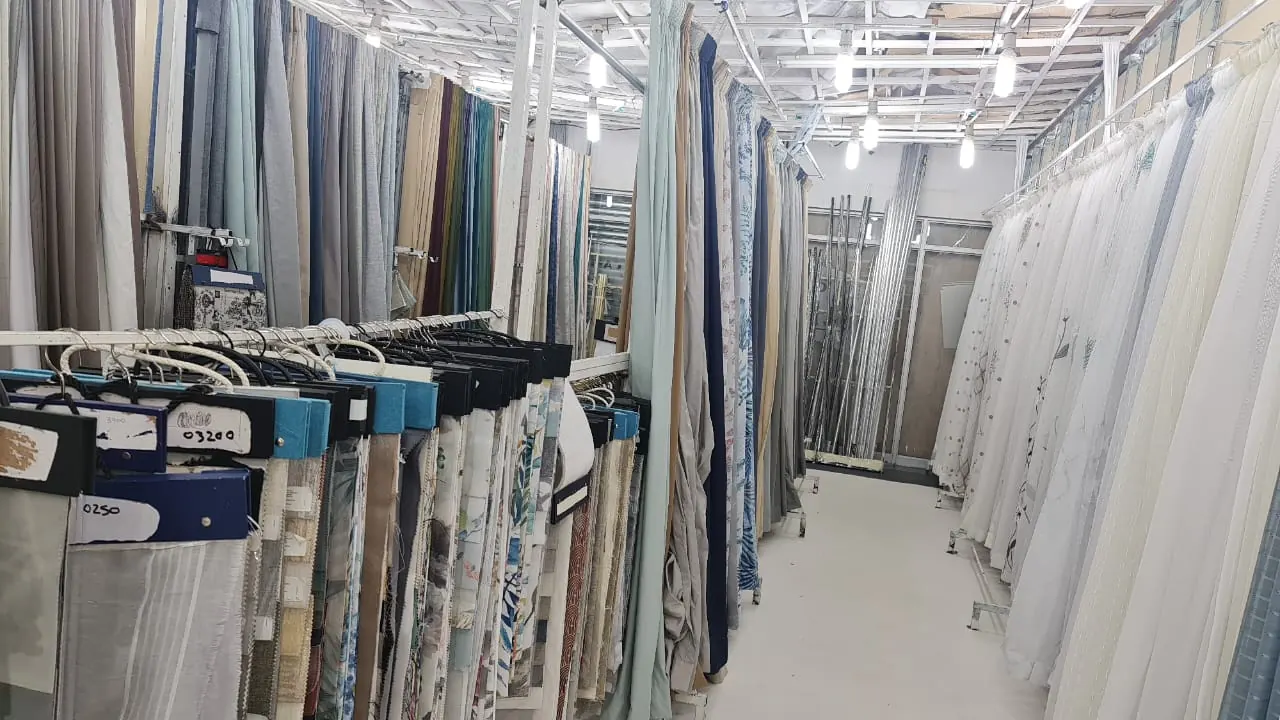 Inside the shop: aisles of curtain fabric and sample books